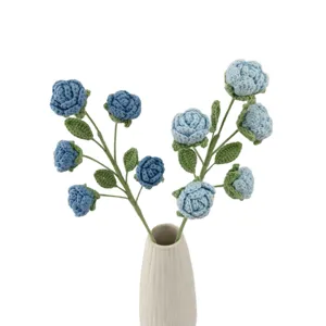 Handmade crochet blue rose bouquet knitted artificial flowers in white ceramic vase decor.