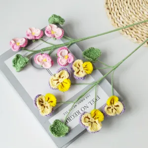 Handmade crochet pansies flower detail, delicate knitted floral stem decoration for home.
