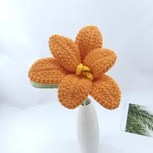 Handmade crochet flower detail showing orange petals and delicate yellow stamen craftsmanship.
