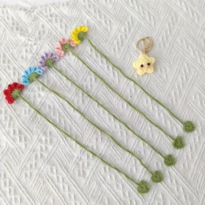 Handcrafted crochet flower bookmarks detail view with cute star keychain, delicate knit crafts.
