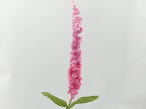 Handgefertigte rosa Häkelblume Detail zeigt feine Garnstiche und Handwerkskunst für Dekor.