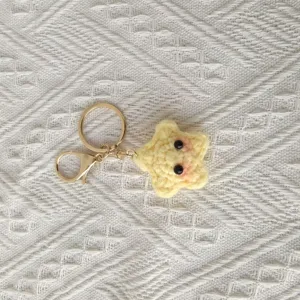Handmade cute yellow star crochet keychain with gold metal ring for bags and keys.
