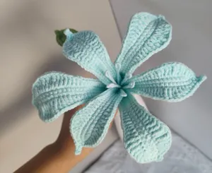 Handmade crochet light blue flower detail, knitted floral craft close-up, desktop decor