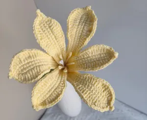 Handmade crochet yellow flower detail shot, perfect for home desktop decoration and crafts.