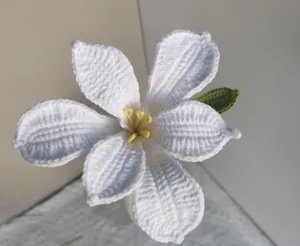 Handcrafted crochet white flower detail shot, perfect for home decor and photography.