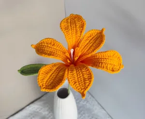 Handmade crochet orange flower detail closeup, delicate yarn floral decor for home photography.