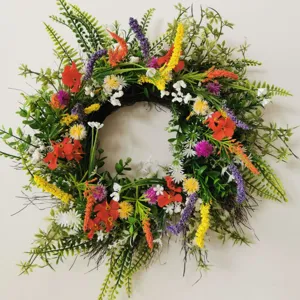Detail view of the colorful artificial wild flower wreath, perfect for spring and summer home wall decor.