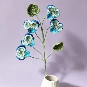 Detailed view of handmade crochet pansy flower bouquet, beautiful knitted floral home decor.