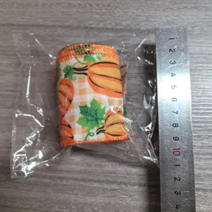 Thanksgiving fabric ribbon roll with autumn pumpkin and maple leaf patterns for DIY crafts decor.