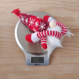 Christmas gnome plush doll detail showing weight specification, festive red knitted hat winter decor.
