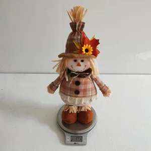 Thanksgiving scarecrow plush doll detail view, autumn harvest sunflower maple leaf ornament.