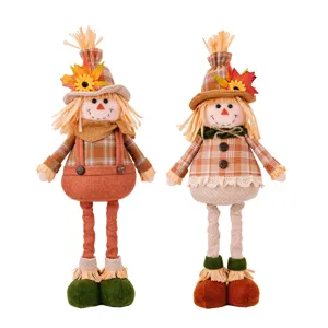 Autumn Thanksgiving scarecrow doll pair with sunflower and maple leaf for home decor.