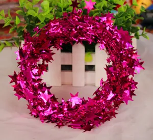 Pink star tinsel garland detail showing shiny metallic elements for Christmas tree.
