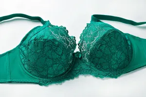 Close-up details of the elegant green lace plus size bra, featuring delicate floral cups.