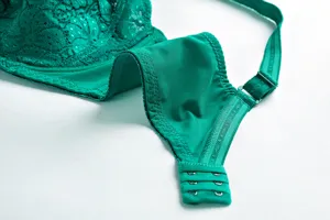 Green lace plus size bra detail showing cup texture, adjustable strap and back closure.