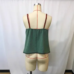 Detail view of back of green Chinese style vintage camisole top with black lace trim.
