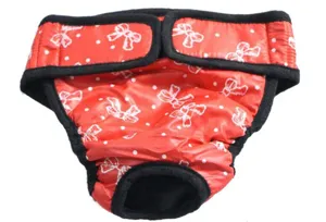Vista di dettaglio dei pantaloni fisiologici per cani con stampa a fiocco rosso e chiusura in velcro.
