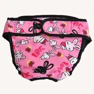Cute pink dog physiological pants with cartoon rabbit print and secure velcro closure for pets.