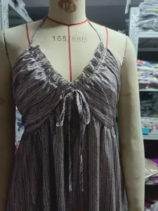 Close-up detail of women's halter V-neck tie-front maxi dress with chic stripe print.