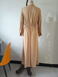 Back view details of casual long sleeve pleated midi dress in solid khaki, simple design.