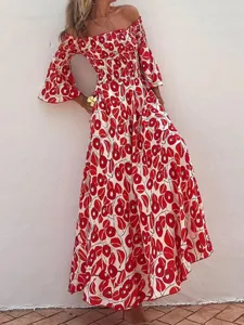 Detail shot of the off-the-shoulder red and white floral maxi dress with smocked bodice.