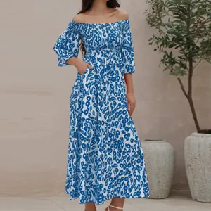 Details of the blue and white floral off-the-shoulder maxi dress with pockets and smocked bodice.