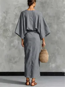 Detailed back view of grey linen two piece outfit with batwing top and slit long skirt.