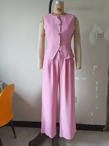 Pink suit vest and wide leg pants detail view, solid color professional office style set.