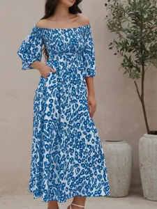 Close-up detail of blue and white floral off-shoulder maxi dress with side pockets.
