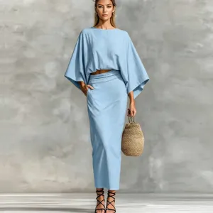 Cotton linen two-piece set detail view, featuring a light blue batwing top and matching long skirt.