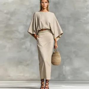 Linen two-piece set featuring a batwing crop top and high-waisted long skirt detail.