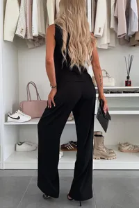 Detailed back view of a black sleeveless vest and trousers set in a modern walk-in closet.