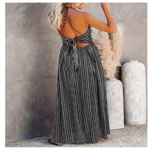 Detail shot of backless halter maxi dress with black and white vertical stripes.