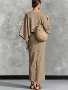 Detail view of women khaki cotton linen set batwing top and long skirt outfit backdrop.