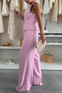 Pink sleeveless vest and wide leg trousers set, elegant summer office outfit detail.