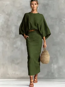 Detailed view of the olive green batwing sleeve top and pocket long skirt outfit in a natural pose.