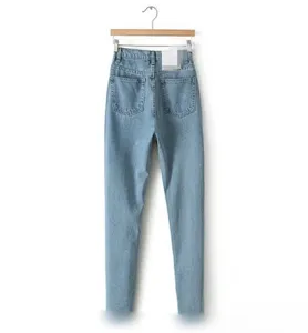 Back view detail of light blue high waist casual women denim jeans hanging on wooden hanger
