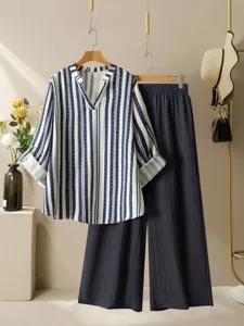 Close-up detail presentation of summer casual striped V-neck blouse and pleated trousers.