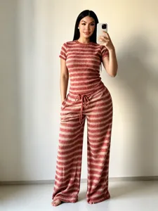 Detailed view of women's striped knit short sleeve top and wide leg pants leisure set.