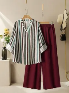 Detailed view of the chic striped V-neck blouse and maroon pleated wide-leg pants set.
