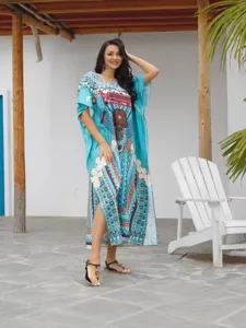 Boho tribal print kaftan dress detail, showing turquoise fabric, V-neck, and loose batwing sleeves.