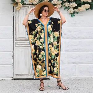 Detail view of a floral printed loose kaftan maxi dress with vibrant border trim.