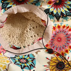 Vue detaillee de l'interieur du chapeau de paille d'ete, tissu imprime et cordon reglable.
