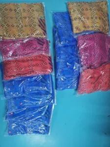 Detailed view of packaged printed cardigans in transparent bags, showing assorted colors.