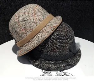Detail shot of stylish tweed bucket hats featuring plaid patterns and chic brim details.
