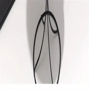 Black metal wire structure detail shot, minimalist design, elegant hat accessory.