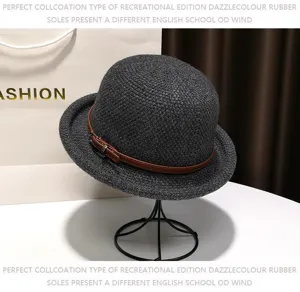 Classic black wool dome hat with brown leather belt detail, elegant vintage bowler hat style.