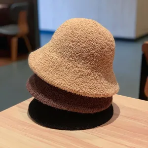 Detailed shot of three stacked autumn winter wool bucket hats in beige brown and black colors.