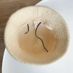 Classic beige knit bucket hat for women, soft wool winter basin cap for daily wear.