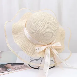 Women's summer straw sun hat with wide mesh brim and elegant bow ribbon for beach travel.